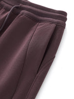 Detail of side pocket and seam on brown Essential Drawstring Straight-Leg Sweatpants, highlighting soft cotton-blend fabric.