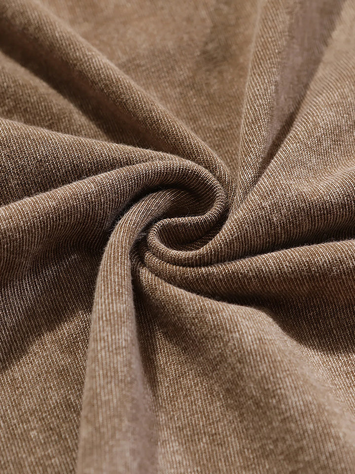 Brown textured fabric with stitched seam