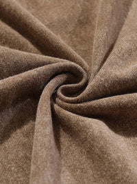 Brown textured fabric with stitched seam