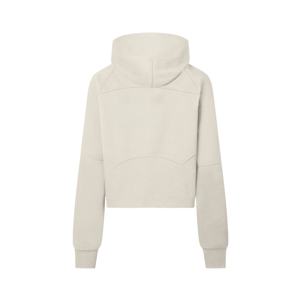 Back view of beige cropped half-zip hoodie for women, showcasing hood and curved seam details for a modern athletic look.