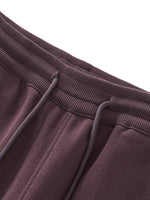 Close-up of waistband on brown Essential Drawstring Straight-Leg Sweatpants with ribbed texture and adjustable drawstring.