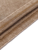 Brown textured fabric with stitched seam