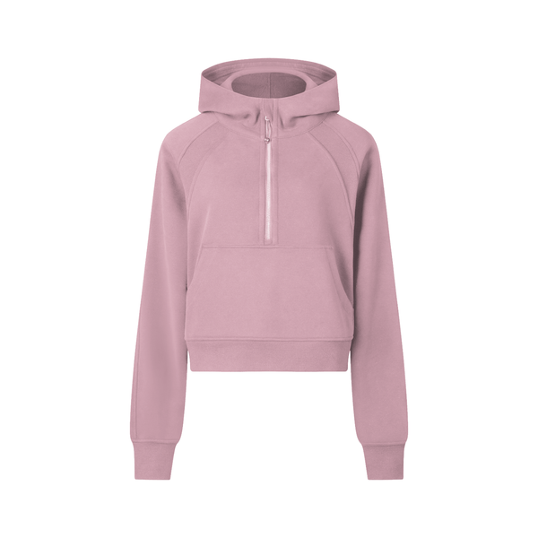 Pink cropped half-zip hoodie for women designed for gym or casual wear, featuring ribbed hem and sporty silhouette.