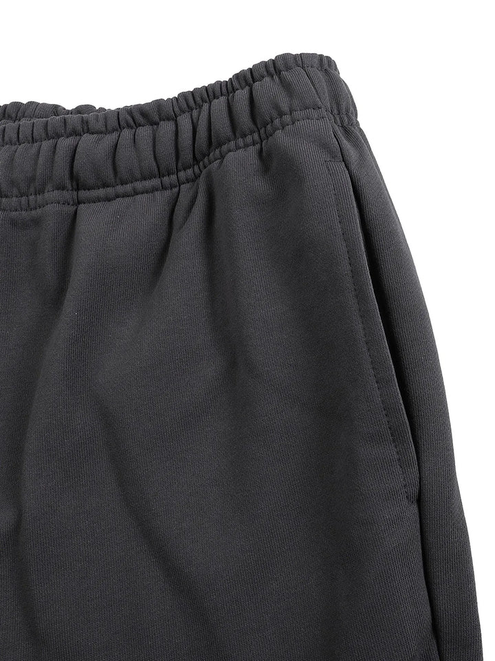 Side pocket detail on Mr Rogers FNDMNTLS Flared Sweatpants in black, emphasizing functionality and soft cotton texture.