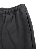 Side pocket detail on Mr Rogers FNDMNTLS Flared Sweatpants in black, emphasizing functionality and soft cotton texture.