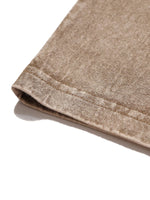 Brown textured fabric with stitched seam