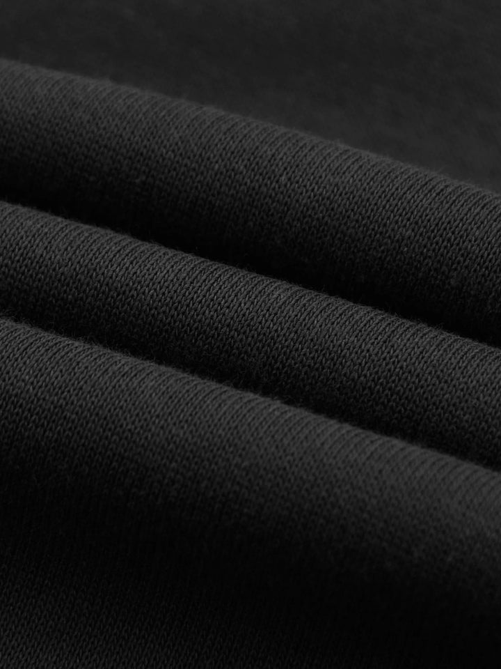 Layered view of black cotton fabric from Essential Cotton T-Shirt hoodie, emphasizing 320 GSM thickness and quality.