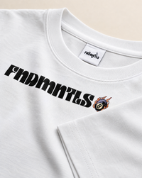 Close-up of a white crewneck t-shirt featuring a black 'FINDMNTS' logo across the chest and a small flaming billiards 8-ball graphic next to it. The inner neck label also displays the 'FINDMNTS' brand name.