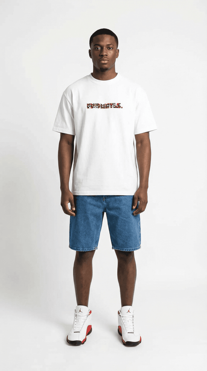 Model wearing white heavyweight cotton T-shirt with colorful geometric logo on front, denim shorts, and white sneakers