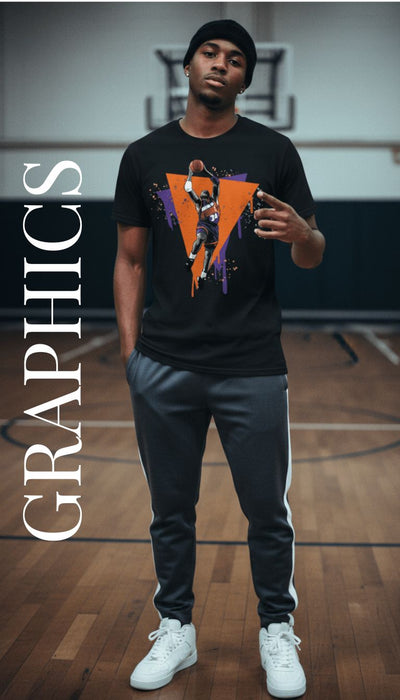 A man standing on a basketball court wearing a black graphic t-shirt with a large orange and purple triangular design, dark gray sweatpants with white side stripes, and white sneakers. The word 'GRAPHICS' is printed vertically on the left side of the image.