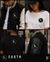 A four-panel collage showing apparel with a circular bird logo: a man wearing a black-and-cream varsity jacket, a woman wearing a white T-shirt, a man wearing a black T-shirt from the back, and a close-up of the sleeve logo on a varsity jacket. Text at the bottom reads EARTH and Stay Grounded, with FND MNT LS.