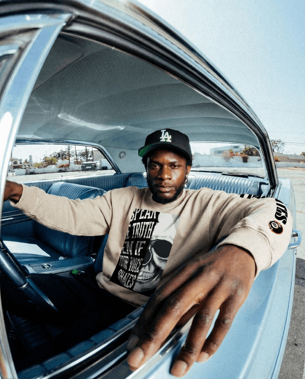 Snow Washed Oversized Sweatshirt | Unisex, Loose, Long Sleeve styled on a male model in a vintage car, showcasing casual streetwear appeal.