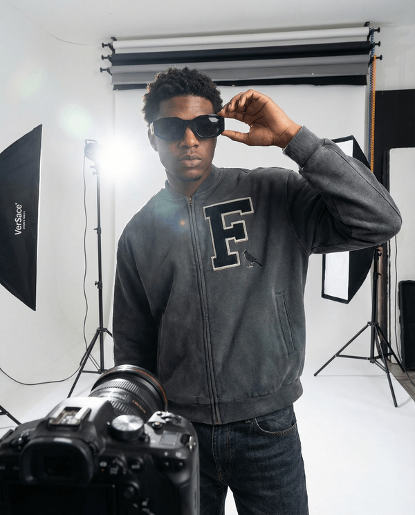 Oversized Vintage Washed Fleece Baseball Jacket featuring bold 'F' patch and bird embroidery, styled with sunglasses in photo shoot.