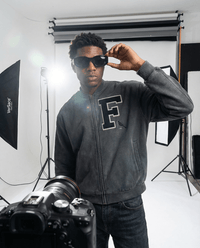 Oversized Vintage Washed Fleece Baseball Jacket featuring bold 'F' patch and bird embroidery, styled with sunglasses in photo shoot.