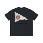 Black Standard Bearer Vintage Wash T-Shirt with a waving flag and medieval crest with the brand name, FNDMNTLS, below the flag