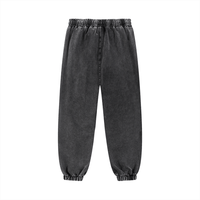 Back view of charcoal black unisex snow wash sweatpants featuring elastic waistband and cuffs. Comfortable cotton blend for everyday use.