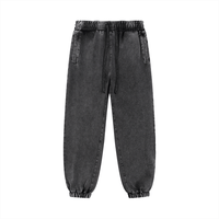 Unisex snow wash sweatpants in charcoal black with drawstring waist and side pockets. Cotton blend fabric ideal for casual and outdoor wear.