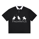 Black contrast polo shirt with white collar and FNDMNTLS logo, unisex cotton blend for casual everyday wear.