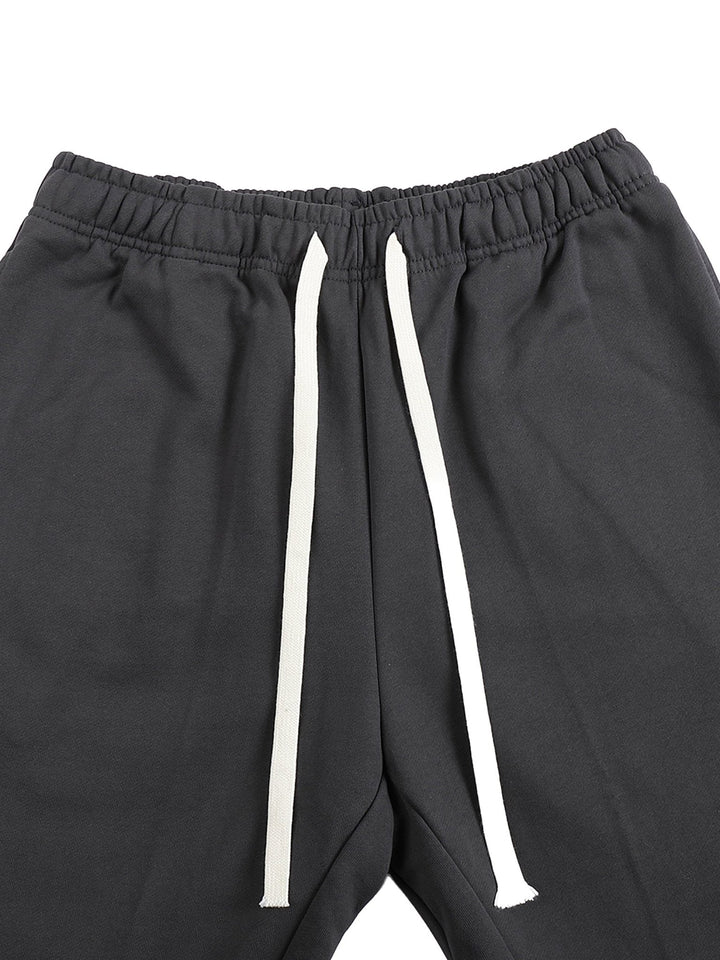 Close-up of waistband on Mr Rogers FNDMNTLS Flared Sweatpants, showing white drawstring and elastic band for adjustable fit.