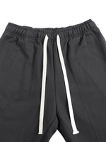 Close-up of waistband on Mr Rogers FNDMNTLS Flared Sweatpants, showing white drawstring and elastic band for adjustable fit.