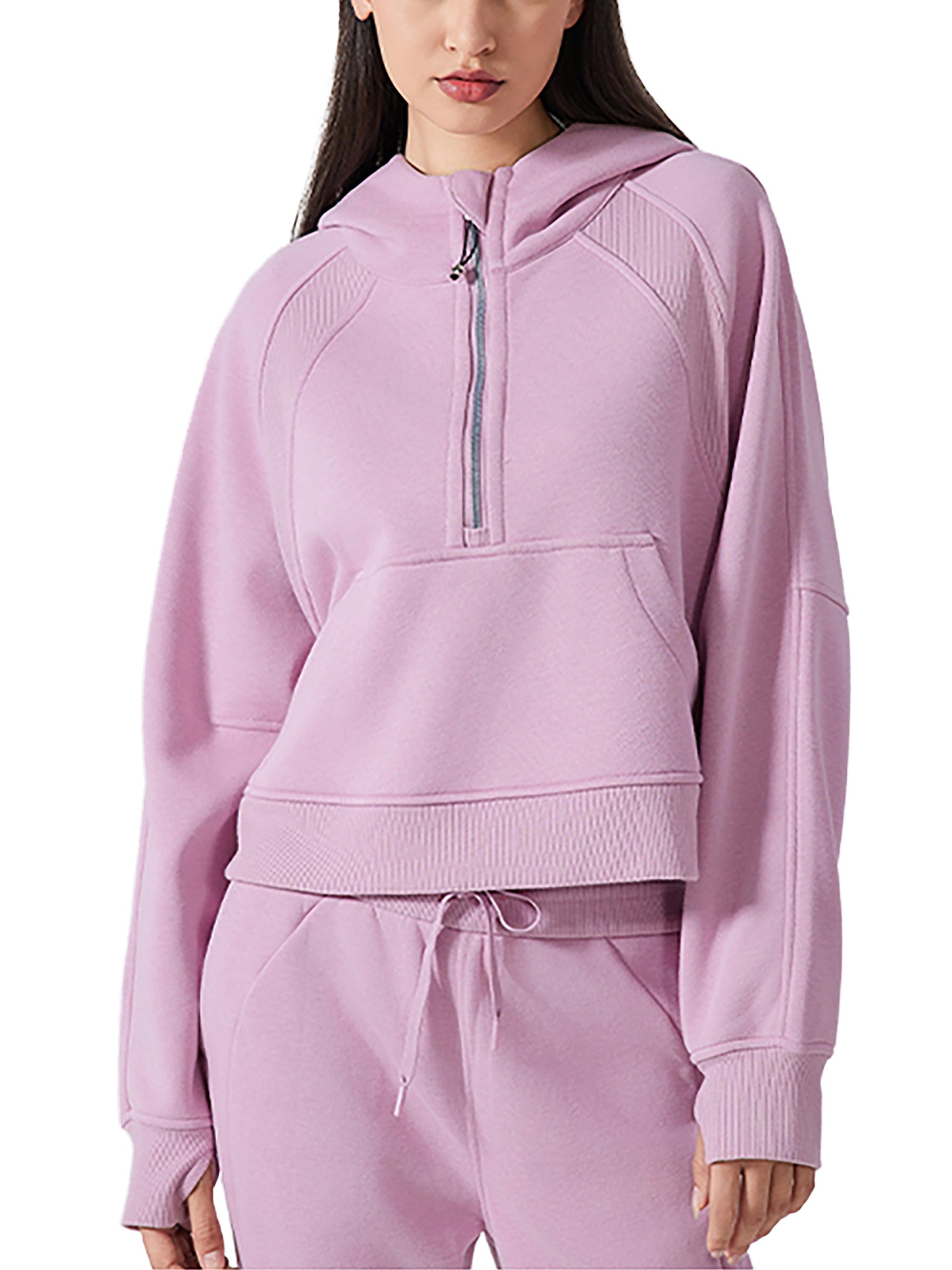 Model in pink cropped half-zip hoodie and matching joggers, showcasing a sporty and coordinated athleisure look.
