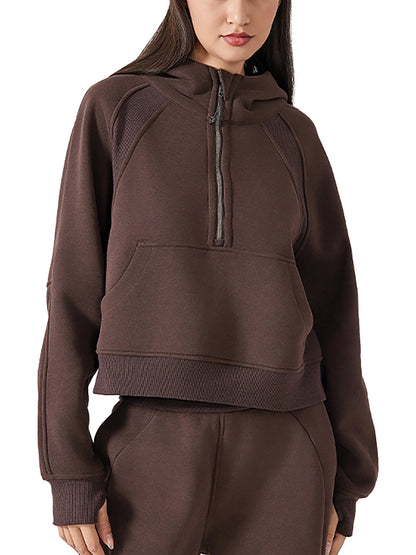 Model wearing chocolate brown cropped half-zip hoodie and joggers, perfect for gym sessions or relaxed casual wear.