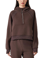 Front view of model in chocolate brown cropped half-zip hoodie for women, highlighting the sporty fit and ribbed hem.