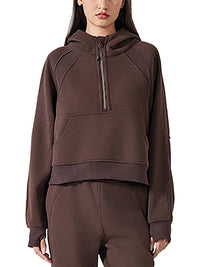 Front view of model in chocolate brown cropped half-zip hoodie for women, highlighting the sporty fit and ribbed hem.