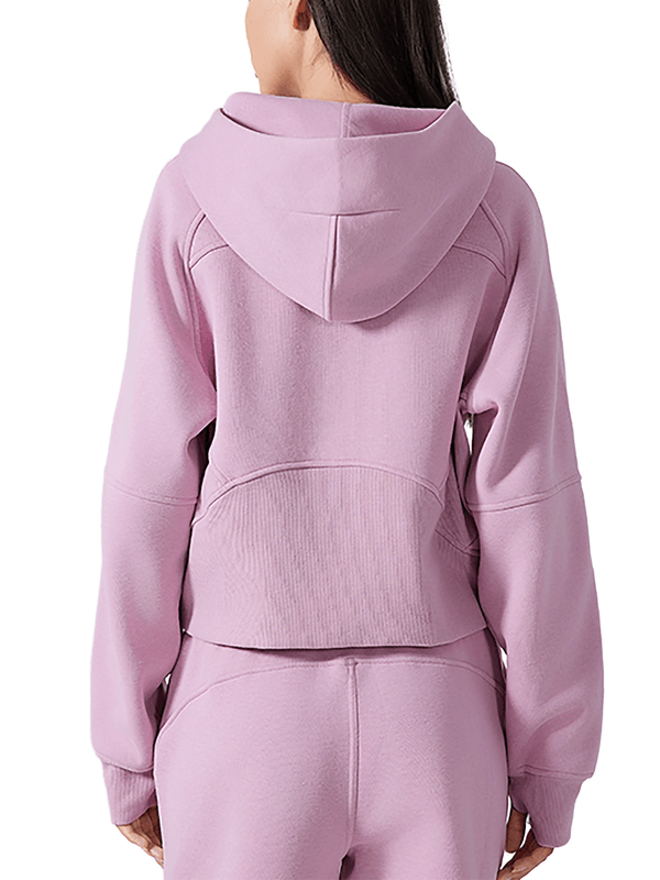 Rear view of model in pink cropped half-zip hoodie for women, displaying the hood and back seam details.