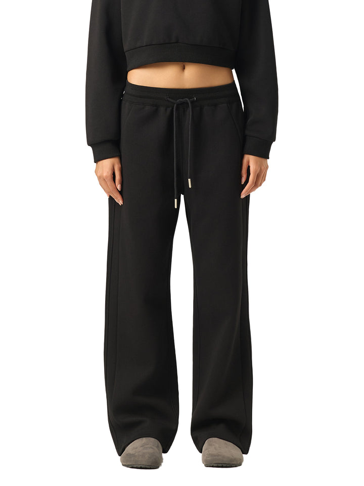 Model wearing black Essential Drawstring Straight-Leg Sweatpants styled with a cropped sweatshirt, perfect for gym or casual wear.