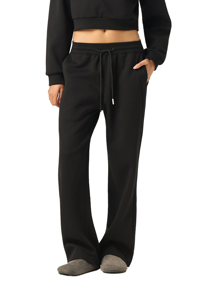 Front angled view of model in black Essential Drawstring Straight-Leg Sweatpants, ideal for casual or sporty spring outfits.