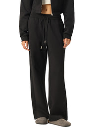 Side view of model in black Essential Drawstring Straight-Leg Sweatpants, showcasing relaxed fit and drawstring waist.