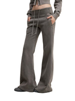 Side view of model in charcoal gray Vintage Washed Flared Fleece Pants with pockets and relaxed fit. Great for everyday comfort.