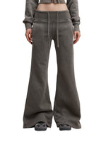 Model wearing charcoal gray Vintage Washed Flared Fleece Pants with drawstring waist and flared legs. Ideal for casual streetwear looks.