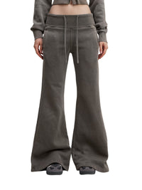 Model wearing charcoal gray Vintage Washed Flared Fleece Pants with drawstring waist and flared legs. Ideal for casual streetwear looks.