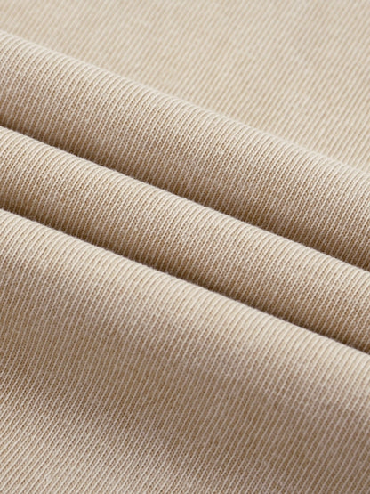 Close-up of beige Mineral Wash Boxy Cotton T-Shirt fabric texture, emphasizing its smooth knit and mineral wash finish.