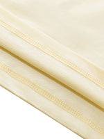 Close-up of beige fabric with a subtle pattern on a white background
