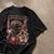 A black short-sleeve graphic t-shirt featuring a collage of Michael Jordan, including his Chicago Bulls jersey number 23, a gold-toned portrait, and red text reading 'MICHAEL JORDAN', laid flat on a textured beige concrete surface.