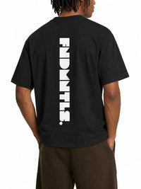 A man wearing a black t-shirt with a large white vertical 'ENDMTS.' logo printed on the back, shown from a rear three-quarter view against a plain white background.